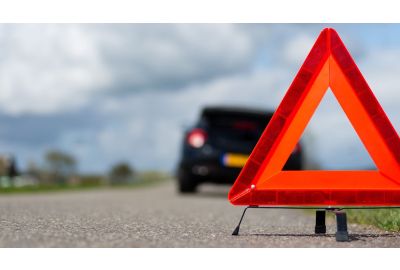 Car broken down with hazard triangle